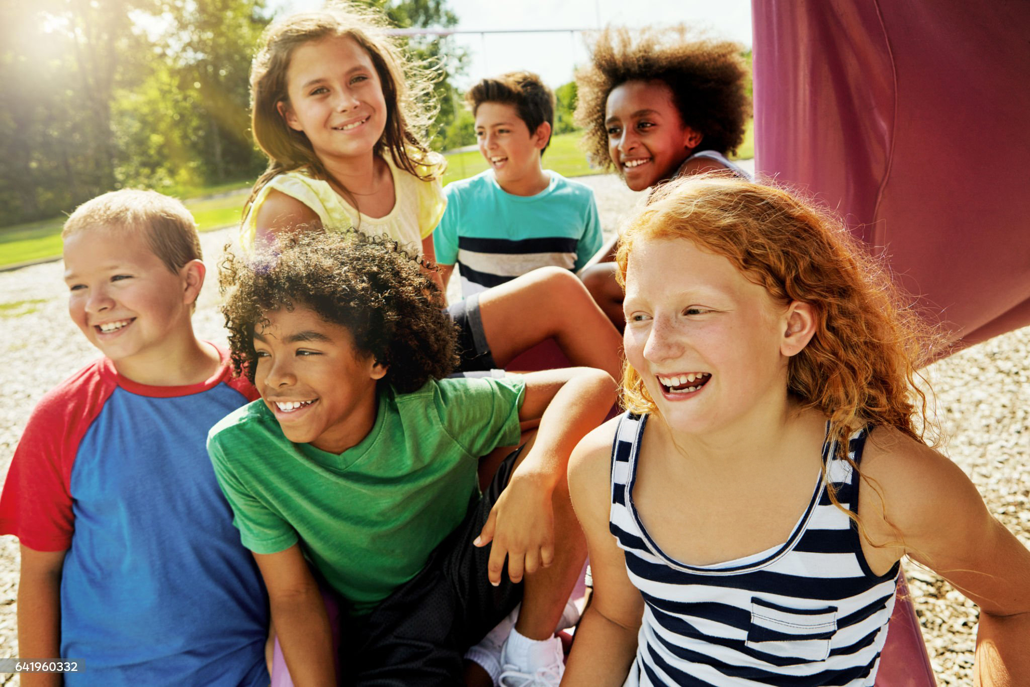 Cropped shot of a group of diverse and happy kids hanging out together outside