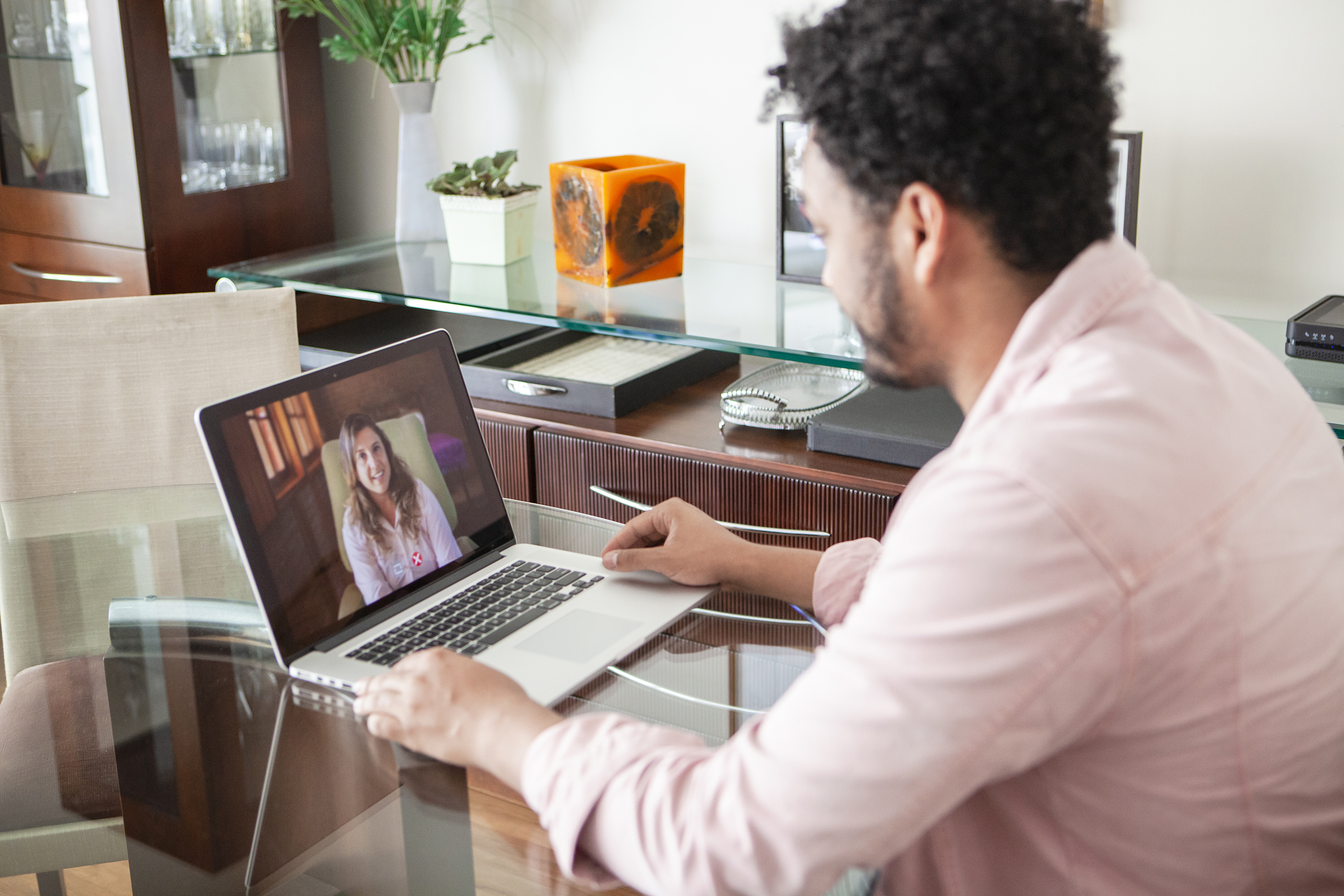 African American young man doing online psychotherapy at home